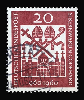 Stamp printed in Germany showing the Michaelskirche in Hildesheim and the bishop's regalia. Millenary of Bishops St. Bernward and St. Godehard, Hildesheim, circa 1960