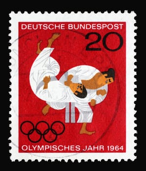 Stamp printed in Germany showing Olympic Games in Tokyo, Japan Judo, olympic rings, circa 1964