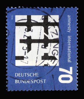 A stamp printed in Germany shows Broken Bars of Prison Window,     “Amnesty International,” an organization for the protection of the rights of political, nonviolent, prisoners, circa 1974
