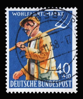 Stamp printed in Germany shows Farmer with pitchfork, circa 1958