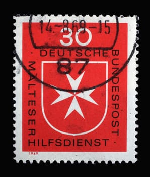 Stamp printed in Germany shows Malteser Cross, Maltese Relief Service, founded 1955, world-wide activities in social services, first aid and disaster assistance, circa 1969