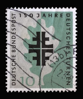 Stamp printed in Germany shows Turner Emblem and Oak Leaf, 150 years of German Turners and on the occasion of the 1958 Turner festival, circa 1958