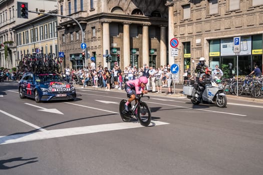 MILAN, ITALY - MAY 30: last stage of Giro 2021, Bernal Gomez leading competitor and Grenadier Team following car at high speed during individual time trial in city streets, shot on may 30, 2021 Milan, Italy.
