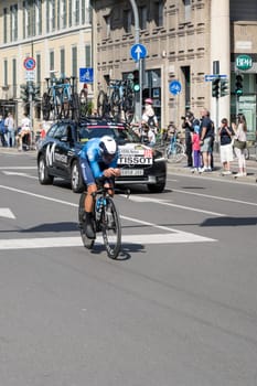 MILAN, ITALY - MAY 30: last stage of Giro 2021, Nelson Oliviera competitor and Moviestar Team  following car at high speed during individual time trial in city streets, shot on may 30, 2021 Milan, Italy.