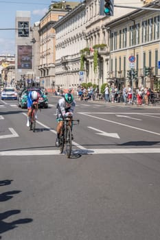 MILAN, ITALY - MAY 30: last stage of Giro 2021, Matteo Fabro competitor of Bora Team and Matteo Badiletti of Groupama Team  at high speed during individual time trial in city streets with their following cars behind, shot on may 30, 2021 Milan, Italy.