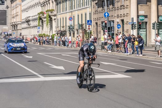 MILAN, ITALY - MAY 30: last stage of Giro 2021, Michael Storer competitor and DSM Team  following car at high speed during individual time trial in city streets, shot on may 30, 2021 Milan, Italy.