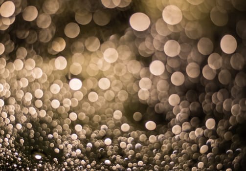 Abstract blurred dark brown light from water drop at the windscreen bokeh background