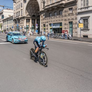 MILAN, ITALY - MAY 30: last stage of Giro 2021, Vladimir Pronskiy competitor and Astana Team following car at high speed during individual time trial in city streets, shot on may 30, 2021 Milan, Italy.