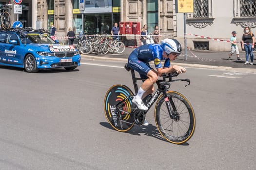 MILAN, ITALY - MAY 30: last stage of Giro 2021, James Knox competitor and Quick-Step Team following car at high speed during individual time trial in city streets, shot on may 30, 2021 Milan, Italy.