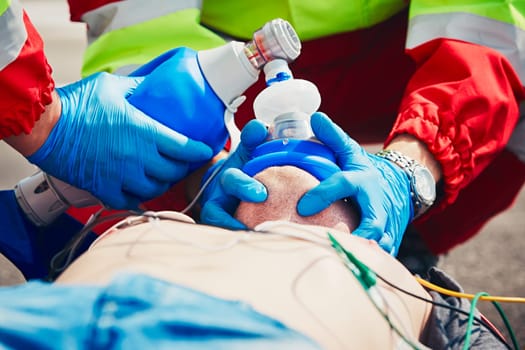 Cardiopulmonary resuscitation. Rescue team (doctor and a paramedic) resuscitating the man on the street.