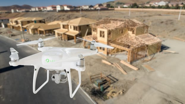 Unmanned Aircraft System (UAV) Quadcopter Drone In The Air Over Construction Site.