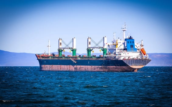 The selective focus bulk cargo ship to harbor quayside Vladivostok
