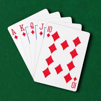 A Diamonds royal flush flat on green card table winning hand business concept