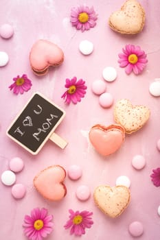 Happy Mothers Day - sweet macarons in heart shape with flowers in pink tone