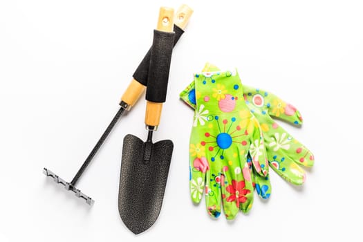 Garden tools with garden gloves on white background. Gardening concept.