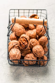 Organic walnuts in basket on kitchen table.