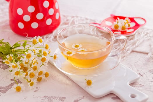 Chamomile herbal tea (Matricaria chamomilla) on kitchen table