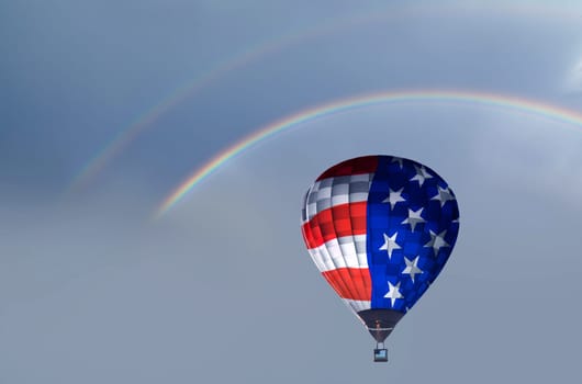Celebrating Independence Day. Hot air balloon with USA flag under rainbow, background for 4th of July