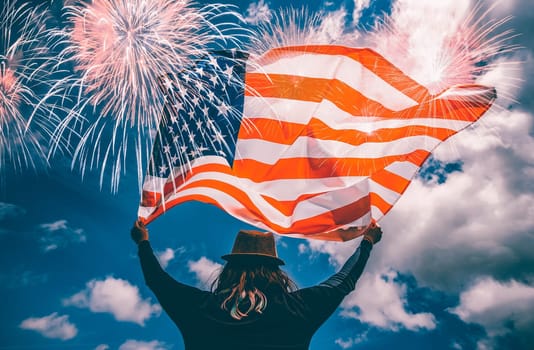 Young happy patriot girl holding the american flag under the 4th of July under fireworks.