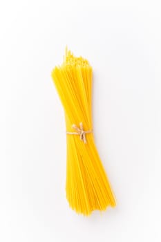 Spaghettini - thinner Spaghetti. Raw Spaghetti on white background.