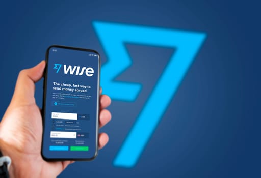 London, UK, May 2021: A hand holding a phone with the Wise app on the screen. Wise is a financial technology company services