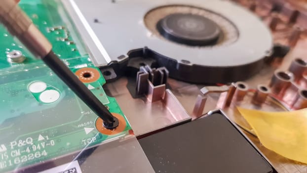 Closeup on a laptop cooler. Maintenance and prevention of the laptop cooling system. Electronic device repair concept. Dust and dirt on the computer fan. Disassembly of the computer