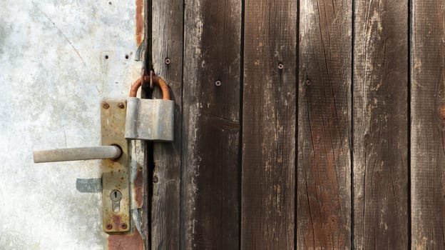 Details of old doors of a wooden house with padlocks. Copy space