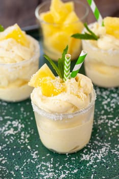 Delicious pineapple soft serve with coconut flakes and mint leaves
