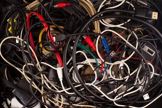front view closeup background texture of many different old computer and phone connection cables