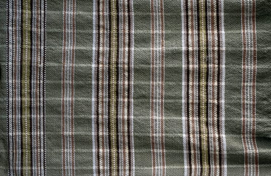 front view closeup of wrinkled cotton towel with woven texture of traditional motifs