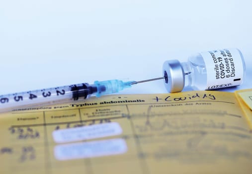 Corona Covid-19 Vaccination with Vaccination Card, Syringe and Vaccine Bottle