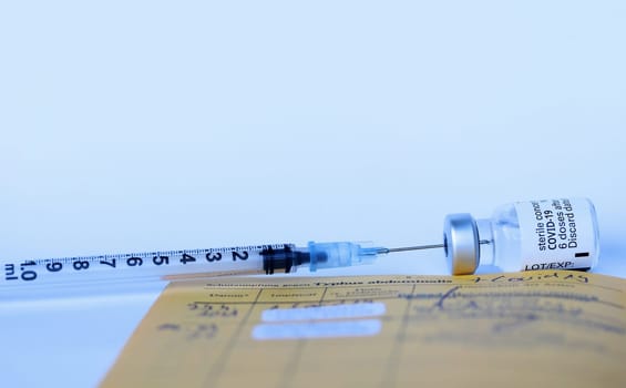 Corona Covid-19 Vaccination with Vaccination Card, Syringe and Vaccine Bottle