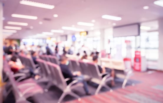 Abstract blur and defocused airport terminal interior with travelers for background. Waiting room