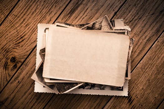 Memories - stock of old and vintage photos on wooden background with copy space