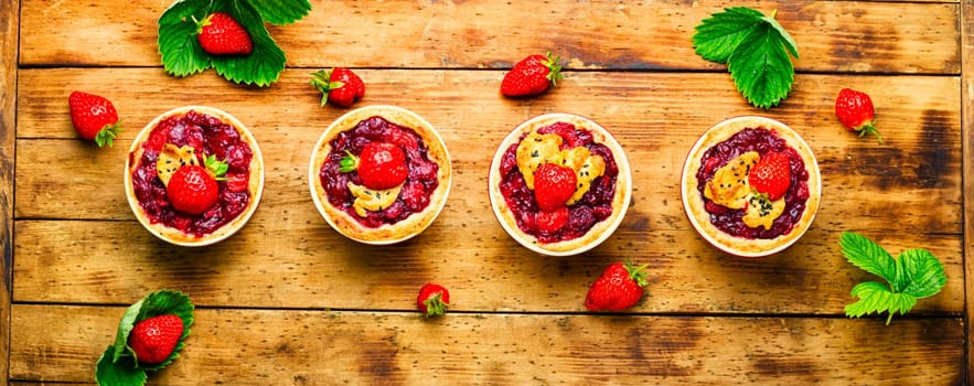 Delicious tartlets with berry jam.Cake with strawberries.