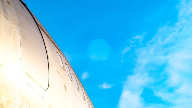 modern airplane parked on airport runway isolated on blue sky background side view of white jet engine passenger