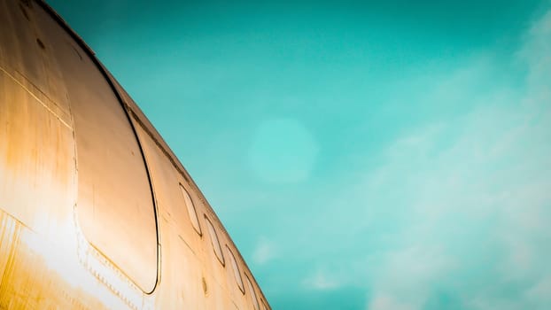 modern airplane parked on airport runway isolated on blue sky background side view of white jet engine passenger