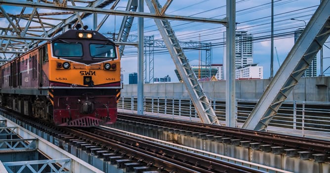 Bangkok Thailand ,Augest 2019 Old vintage train in Thailand riding on iron bridge across river in Bangkok.