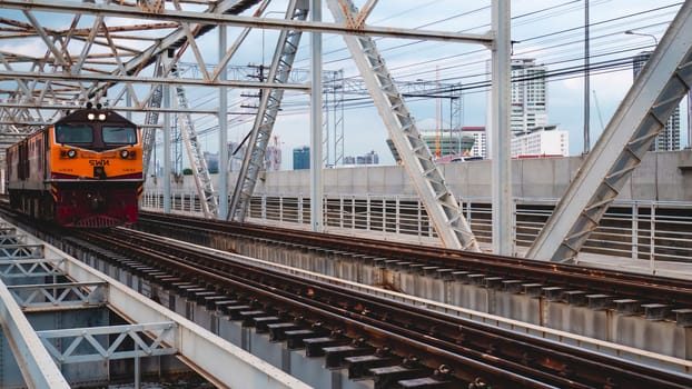 Bangkok Thailand ,Augest 2019 Old vintage train in Thailand riding on iron bridge across river in Bangkok.