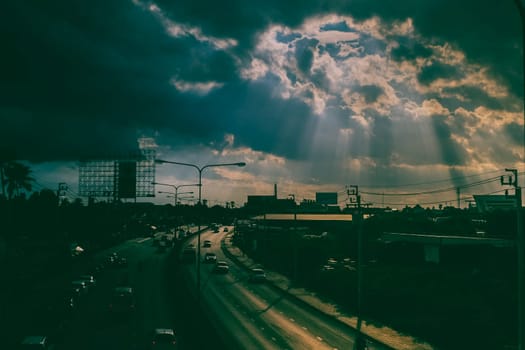 August 2019,Bangkok Thailand  Sun rays shining thru dramatic clouds scanning city of Bangkok below s.God message concept idea. Nature spiritual background. Traffic in city