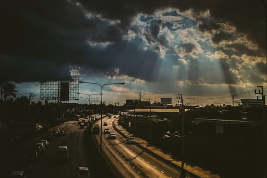 August 2019,Bangkok Thailand  Sun rays shining thru dramatic clouds scanning city of Bangkok below s.God message concept idea. Nature spiritual background. Traffic in city
