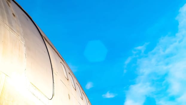 modern airplane parked on airport runway isolated on blue sky background side view of white jet engine passenger