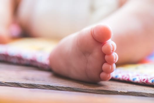 Close up of newborn baby feet, outdoors on baby blanket