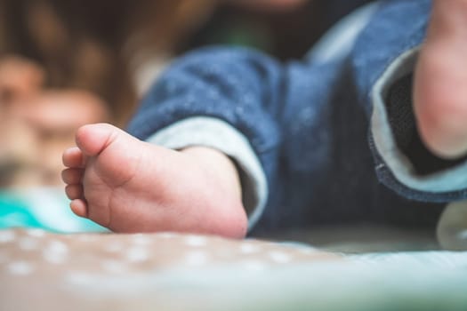 Close up of newborn baby feet on baby blanket