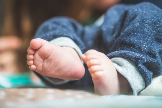 Close up of newborn baby feet on baby blanket