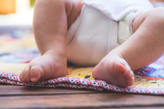 Close up of newborn baby feet, outdoors on baby blanket