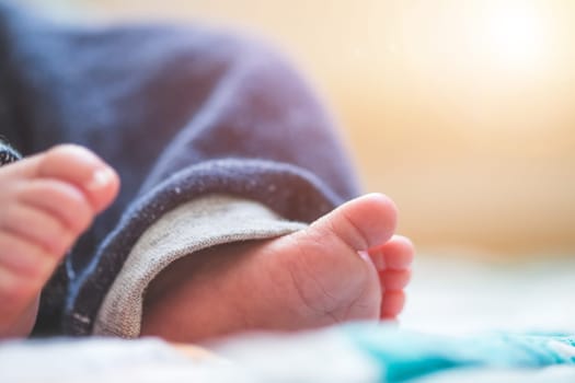 Close up of newborn baby feet on baby blanket