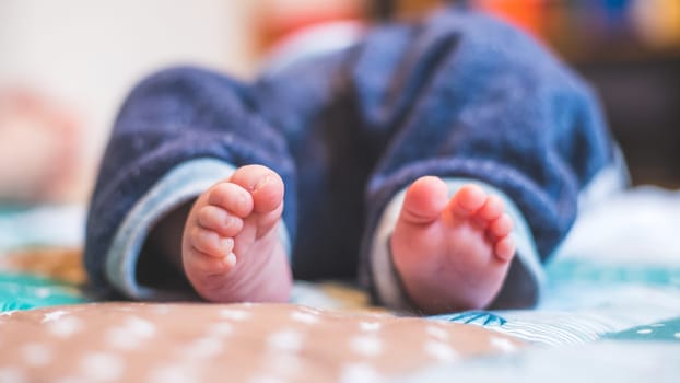 Close up of newborn baby feet on baby blanket