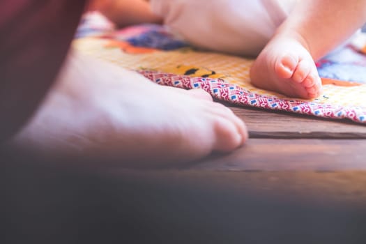 Close up of newborn baby feet, outdoors on baby blanket