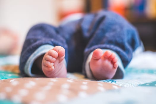 Close up of newborn baby feet on baby blanket